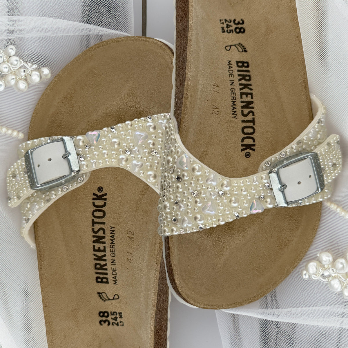 Custom Birkenstock Madrid bridal sandals decorated with ivory pearls with delicate heart and crystal accents on soft bridal tulle.