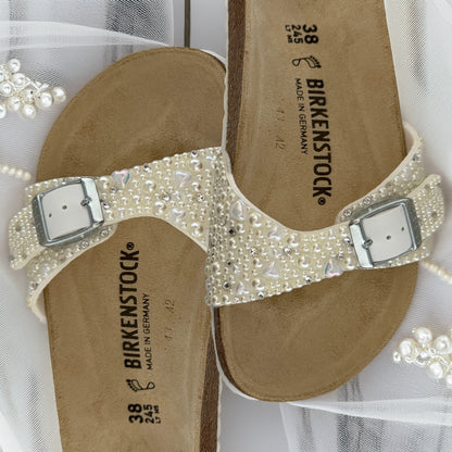 Custom Birkenstock Madrid bridal sandals decorated with ivory pearls with delicate heart and crystal accents on soft bridal tulle.