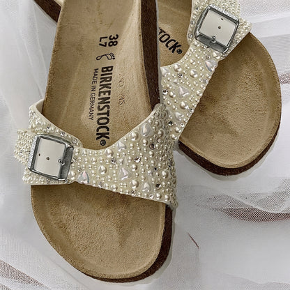 Custom Birkenstock Madrid bridal sandals embellished with ivory pearls with delicate heart and crystal accents on soft bridal tulle.