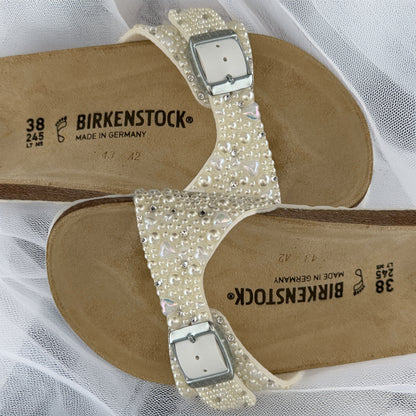 Detailed views of ivory pearl embellishment with delicate heart and crystal accents on custom Birkenstock Madrid bridal sandals.